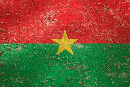 National flag of Burkina Faso  on old peeling wall background.The concept of national pride and symbol of the country.の写真素材