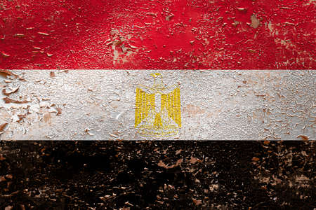 National flag of Egypt  on old peeling wall background.The concept of national pride and symbol of the country.の写真素材