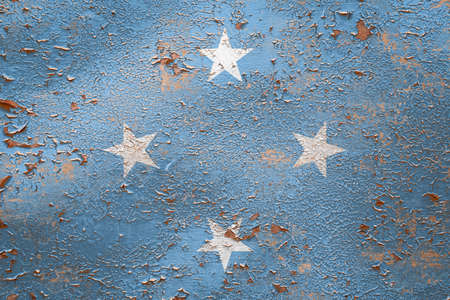 National flag of Federal States of Micronesia on old peeling wall background.The concept of national pride and symbol of the country.の写真素材