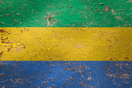 National flag of Gabon on old peeling wall background.The concept of national pride and symbol of the country.の写真素材