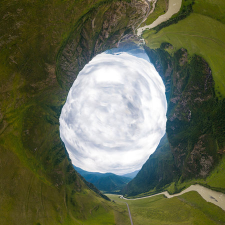 Helicopter drone shot. Aerial photography of a mountain,  green field, road, small village and...