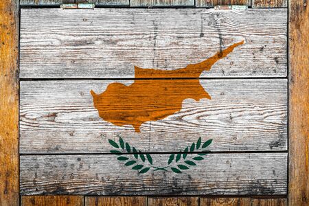 National flag of Cyprus on a wooden wall background.The concept of national pride and symbol of the country.Flag painted on a wooden fence with metal nails.の写真素材