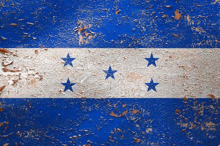 National flag of Honduras  on old peeling wall background.The concept of national pride and symbol of the country.の写真素材