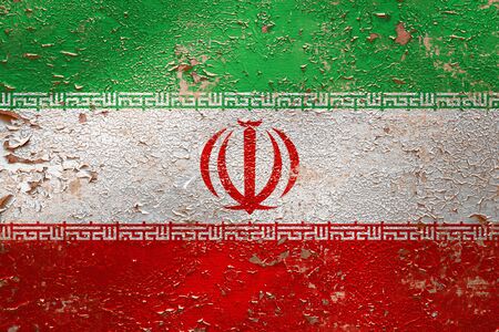 National flag of Iran  on old peeling wall background.The concept of national pride and symbol of the country.の写真素材