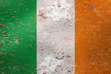National flag of Ireland on old peeling wall background.The concept of national pride and symbol of the country.の写真素材