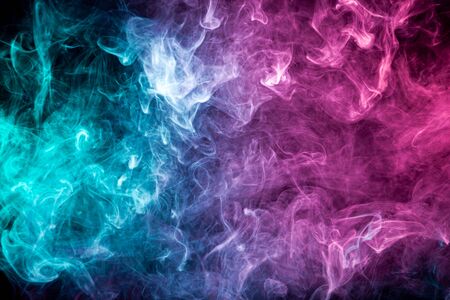 Smoke of pattern pink and blue   on a dark isolated background.  Scary and mysterious symbolの写真素材