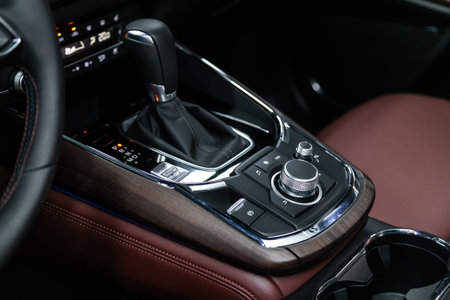 Close-up of the accelerator handle and buttons with  modern central console with  controls....