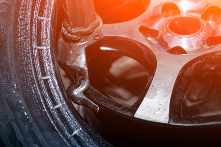 A close-up of tire fitting a car wheel: separating old tires from molten faces using a tire changer....