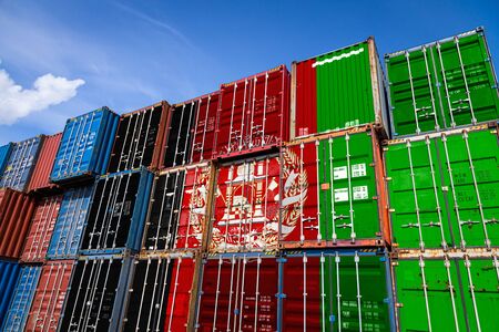The national flag of Afghanistan on a large number of metal containers for storing goods stacked in rows on top of each other. Conception of storage of goods by importers, exportersの写真素材