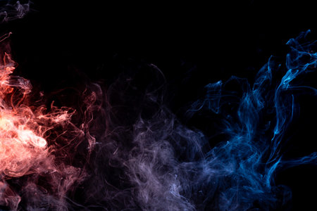 Frozen abstract movement of  explosion smoke multiple blue , redcolors on black background. Background from the smoke of vapeの写真素材