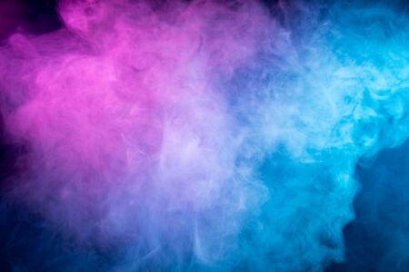 Fog colored with bright pink  and blue gel on dark background. Abstract artwork. Trendy wallpaper. の写真素材