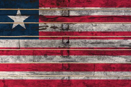 National flag  of Liberia on a wooden wall background.の写真素材