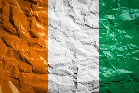 National flag of Cote d'ivoire on crumpled paper. Flag printed on a sheet. Flag image for design on flyers, advertising.の写真素材