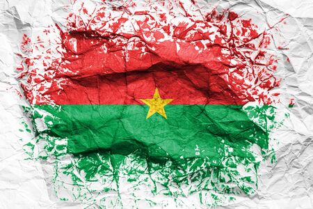 The national flag of the Burkino Faso
  is painted on crumpled paper. Flag printed on the sheet. Flag image for design on flyers, advertising.の写真素材