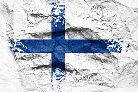 The national flag of the Finland  is painted on crumpled paper. Flag printed on the sheet. Flag image for design on flyers, advertising.の写真素材