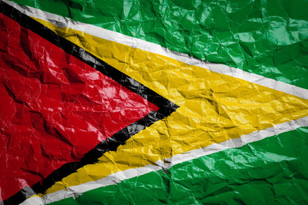 National flag of Guyana on crumpled paper. Flag printed on a sheet. Flag image for design on flyers, advertising.の写真素材