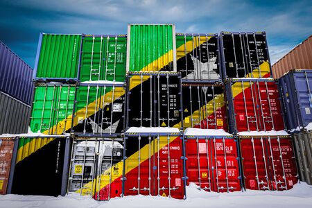 The national flag of Saint Kitts and Nevis on a large number of metal containers for storing goods stacked in rows on top of each other. Conception of storage of goods by importers, exportersの写真素材