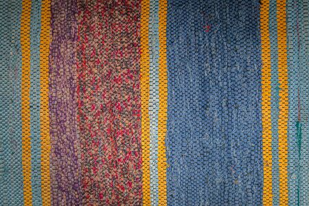 Close-up of a striped red blue old carpet.  carpet texture, abstract  geometric ornamentの写真素材