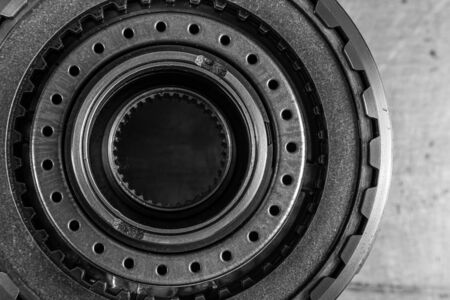 Close-up of a car gearbox. Metallic shiny  gear differential for planetary gearshift. Industrial metal gears for Backgroundの写真素材