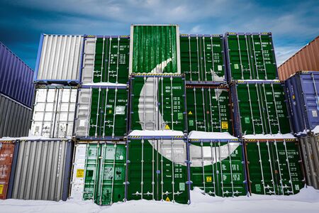 The national flag of Pakistan
 on a large number of metal containers for storing goods stacked in rows on top of each other. Conception of storage of goods by importers, exportersの写真素材