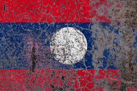 National flag of Laos on old peeling wall background.The concept of national pride and symbol of the country.の写真素材