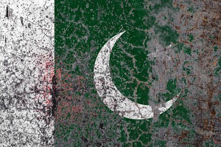 National flag of Pakistan  on old peeling wall background.The concept of national pride and symbol of the country.の写真素材