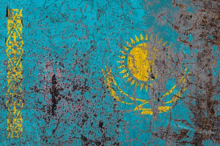 National flag of Kazakhstan on old peeling wall background.The concept of national pride and symbol of the country.の写真素材