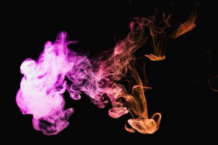 Smoke of pattern pink and red  on a dark isolated background.  Scary and mysterious symbol
の写真素材