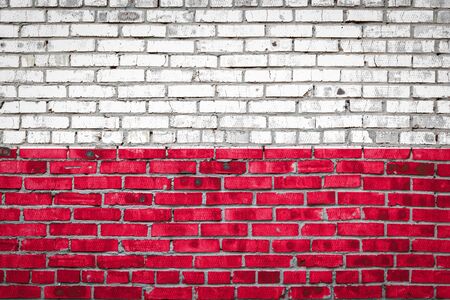 National flag of Poland  depicting in paint colors on an old brick wall. Flag  banner on brick wall background.の写真素材
