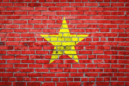 National flag of Vietnam  depicting in paint colors on an old brick wall. Flag  banner on brick wall background.の写真素材