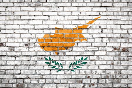 National flag of Cyprus  depicting in paint colors on an old brick wall. Flag  banner on brick wall background.の写真素材