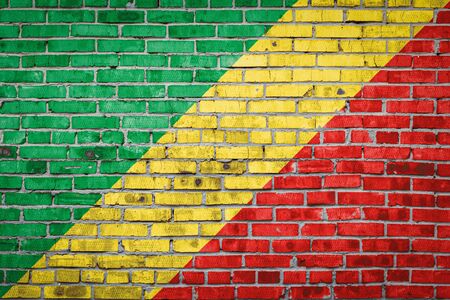 National flag of Republic of the Congo depicting in paint colors on an old brick wall. Flag  banner on brick wall background.の写真素材