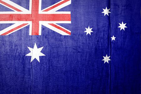 National flag of Australia depicting in paint colors on old clothl. Flag  banner on  fabric texture background.の写真素材