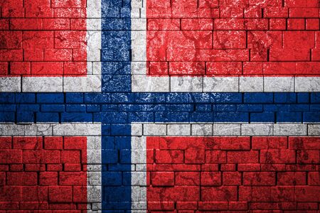 National flag of Norway on brick  wall background.The concept of national pride and symbol of the country. Flag  banner on  stone texture background.の写真素材