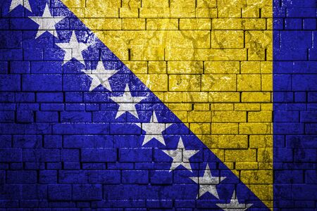 National flag of Bosnia Herzegovina on brick  wall background.The concept of national pride and symbol of the country. Flag  banner on  stone texture background.の写真素材