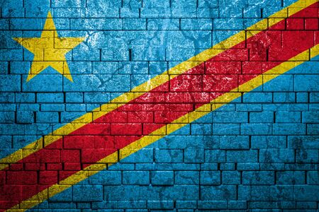 National flag of Democratic Republic of the Congo on brick  wall background.The concept of national pride and symbol of the country. Flag  banner on  stone texture background.の写真素材