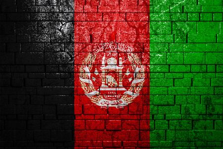 National flag of Afghanistan on brick  wall background.The concept of national pride and symbol of the country. Flag  banner on  stone texture background.の写真素材