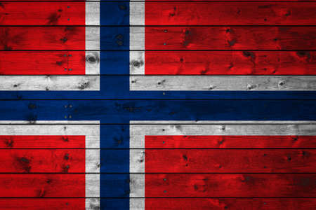 The national flag of Norway is painted on a camp of even boards nailed with a nail. The symbol of the country.の写真素材