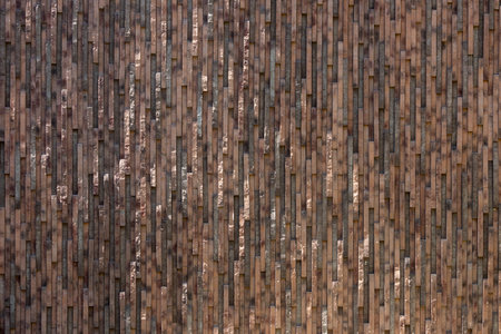Background of brown-gray stone wall made with blocks. Pattern of slate wall texture and background