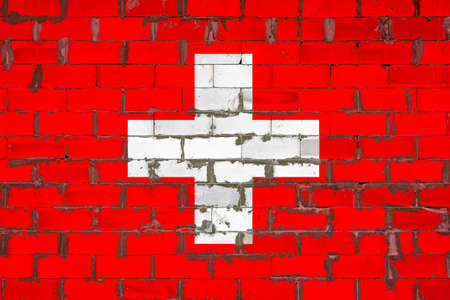 The national flag of Switzerland painted on a wall of sibit blocks with cement. The symbol of the country.の写真素材