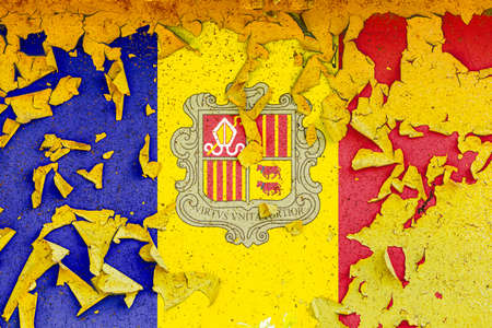 The national flag of Andorra is painted on an old metal wall with ragged paint. Country symbol.の写真素材