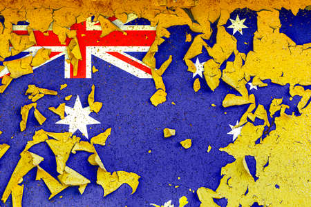 The national flag of Australia is painted on an old metal wall with ragged paint. Country symbol.の写真素材