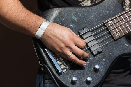 Close-up of a man musician playing the electric guitar
