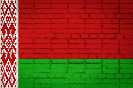 National flag of Belarus depicting in paint colors on an old brick wall. Flag banner on brick wall background.の写真素材