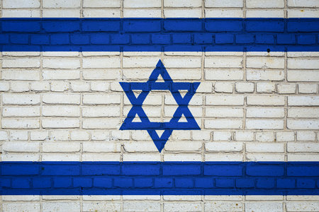 National flag of Israel depicting in paint colors on an old brick wall. Flag banner on brick wall...