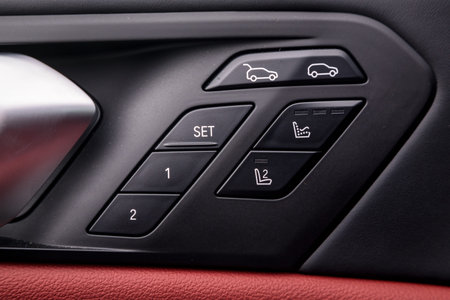 Ð¡lose up of a door control panel with chrome handle on the car door, common black genuine leather...
