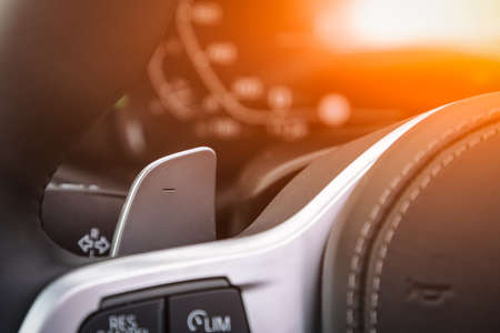 Vehicle interior of a modern car with voice control button. Steering wheel with multifunction buttonsの写真素材
