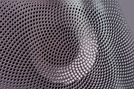 music column close-up. Metal part with holes of the same size, silver pattern. Metal textureの写真素材