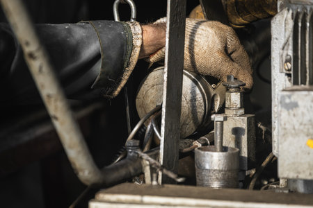 Male worker controls the production process at the factory.Close-up man presses the lever on the...