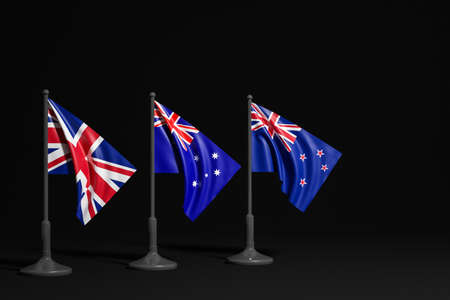 3D illustration of the national flags of United Kindon, Australia and New Zealand on a metal flagpole fluttering on black background. Concept of export-import, transportation, delivery of goods. Competition between countriesの写真素材